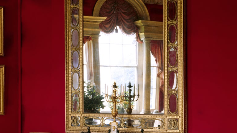 The Octagon Drawing Room, Basildon. View of a Neo-classical gilt pier-glass and table. The pier-table is supported by female figures inspired by the Erechtheum on the Acropolis at Athens.
